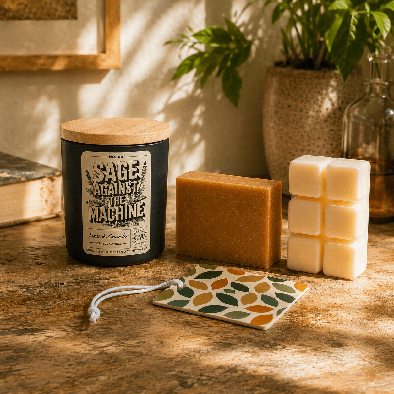 Candle, soap, and wax melts on a wooden surface with a plant in the background